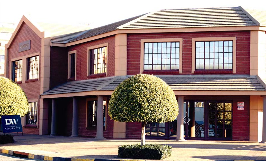 The DW Attorneys office in Welkom: a double-storey red-brick building with a
                    DW Attorneys signboard at the street entrance.